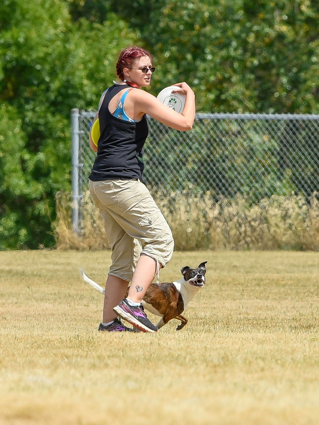 Sara Reusche prepares to throw a disc to dog Pan